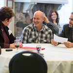 Three people sitting at a table having a conversation